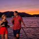 Couple having a drink on the deck of Spirit of Cairns at dusk